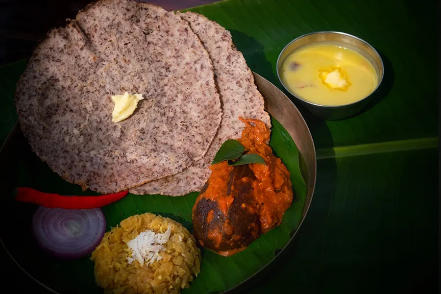 Malenadu meal on a banana leaf with ragi rotti, curry and rice